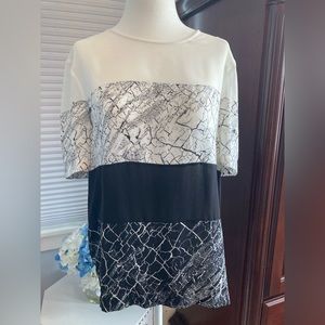 BCBG black white/cream multi-pattern blouse looks great with blazers or jeans